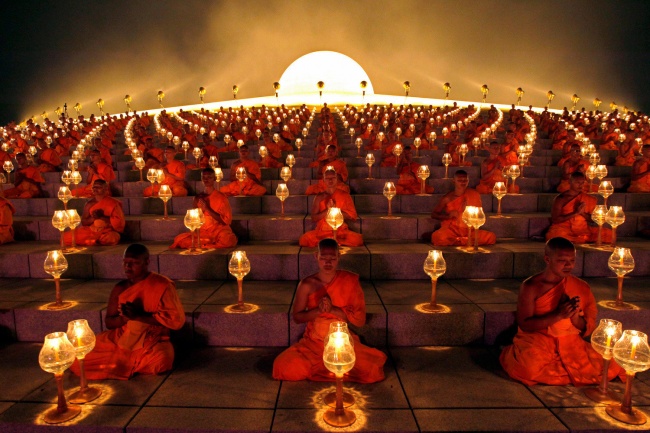 Buddhist monks’ ritual before starting the paper lanterns. Suphan Buri Province, Thailand.