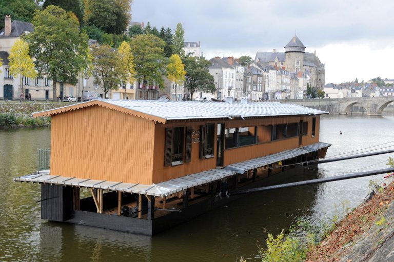 The wash-house boat "Saint Julien" floats after being set back in the Mayenne river, its place of origin, on October 17, 2013 in Laval, western France. The "Saint Julien" is one of two traditional floating wash houses the city of laval has retained since their disappearance with the advent of the washing machine in the 1950s. They were classified in 1993 as National Monuments, part of the French National Heritage Sites. After the collapse of the "Saint Julien's" hull in March 2009, the two boats were removed from the river to be restored, before being put back into place. AFP PHOTO/ JEAN-FRANCOIS MONIER (Photo credit should read JEAN-FRANCOIS MONIER/AFP/Getty Images)
