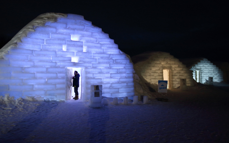 A visitor stands in the doorway to an illuminated room made from snow and ice at night at the Royce' Ice Hills Hotel in Tobetsu, Hokkaido, Japan, on Sunday, Feb. 15, 2015. The seasonal hotel opens from Jan. 17 to March 15 this year. Photographer: Tomohiro Ohsumi/Bloomberg via Getty Images