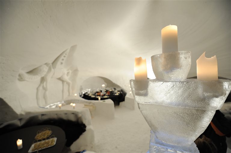 The igloo with snow tables and candles – Iglu-Dorf, Switzerland