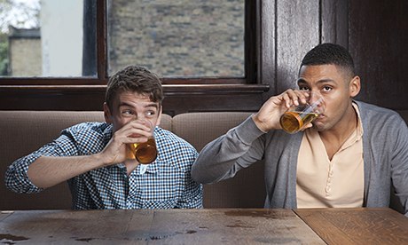Young men drinking beer in bar