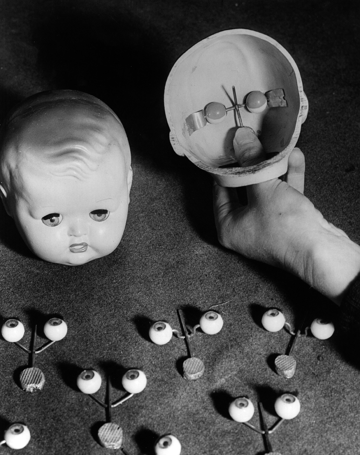 12th January 1949: Dolls eyes and the plastic mouldings used in the manufacture of toys' faces at a factory run by Mr Dominy, in Totton, Southampton. (Photo by Fox Photos/Getty Images)