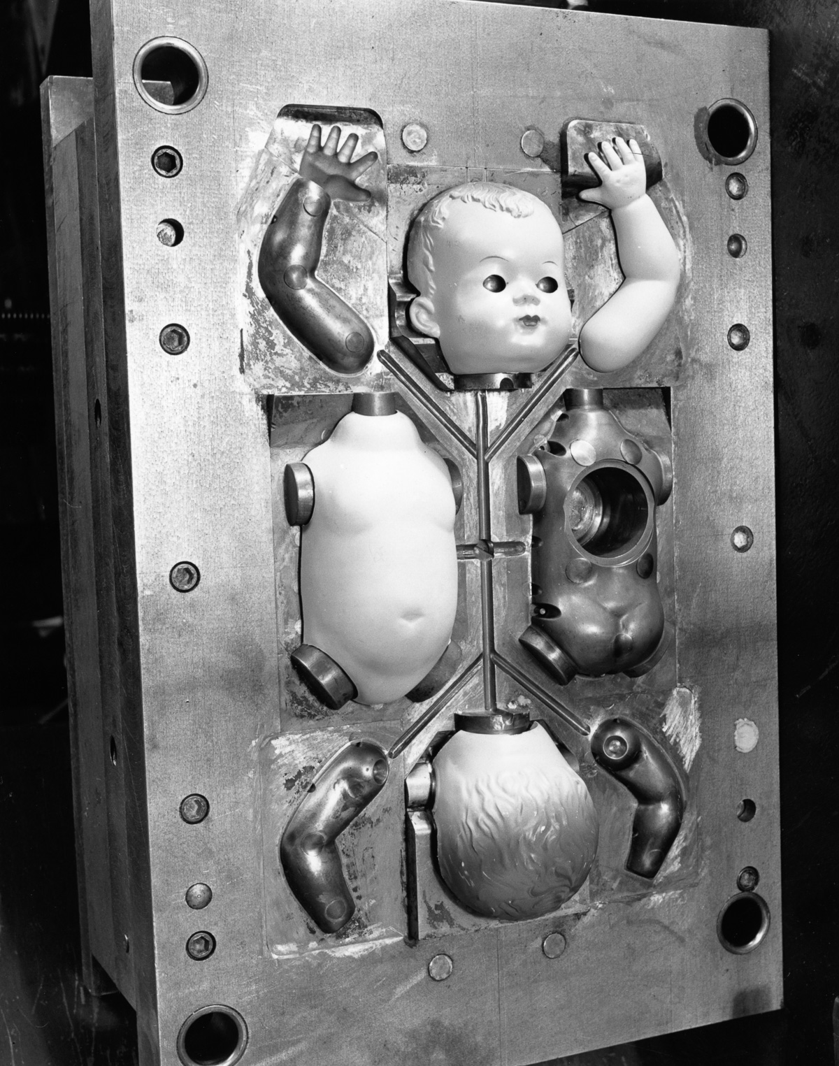 15th December 1951: Parts of a doll in an injection mould at Cascelloid's factory at Leicester. Original Publication: Picture Post - 5617 - Toys Are Big Business - pub. 1951 (Photo by Kurt Hutton/Picture Post/Getty Images)
