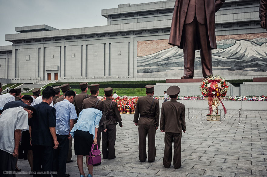 You are only allowed to photograph these statues if both bodies are featured in their entirety. There was an endless stream of North Koreans bringing flowers and bowing