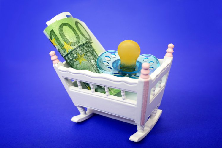 EC3RJN Miniature child s bed with pacifier and euro banknote in it, child care subsidy