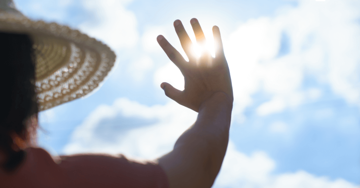 dłoń zasłaniająca słońce
